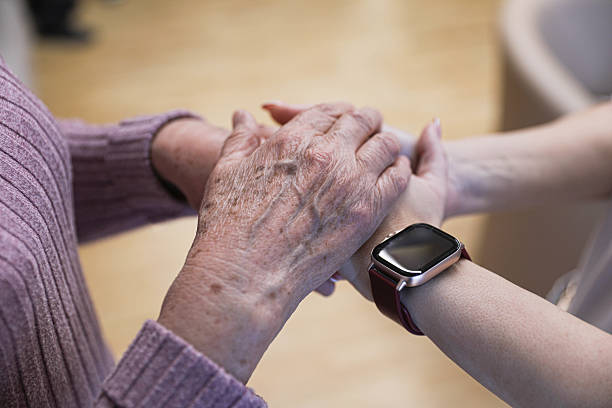 istock Compassionate touch between generations — elderly woman and caregiver 2212429596