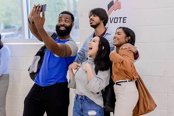 Multiracial group of young adults smiling after voting.  Feeling happy and confident.