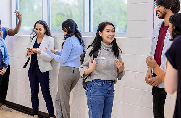 istock Smiling Multiracial Young Adults Talking Together After Voting 2212431613