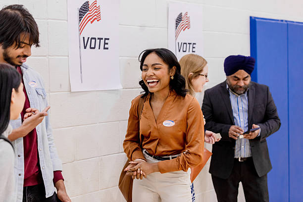 istock Happy Voters Celebrating Democracy at Polling Place 2212431627