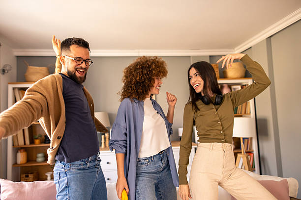istock Three Friends Dancing and Celebrating Joyfully in a Bright and Cozy Room 2212432716