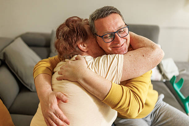 istock Elderly Woman and Her Son Sharing a Precious Hug 2212434698
