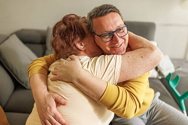 istock Elderly Woman and Her Son Sharing a Precious Hug 2212434700