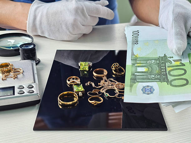 istock A professional is conducting a jewelry appraisal using a scale, while also handling cash concept 2212436089