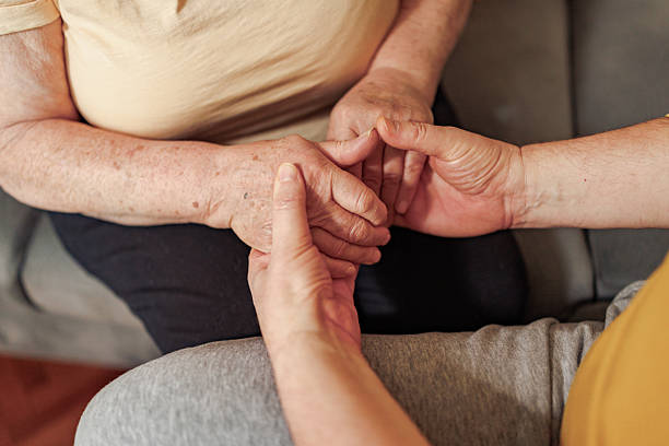 istock Unrecognizable man and woman holding hands at home 2212436185