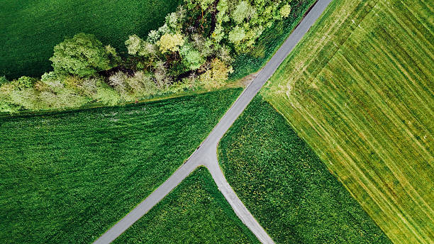 istock Aerial Spring Landscape with Rural Road and Green Fields 2212437910