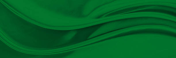 istock Black green satin dark fabric texture luxurious shiny that is abstract silk cloth background with patterns soft waves blur beautiful. 2212438359