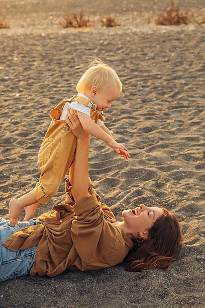 istock Mother and child enjoying playful bonding time outdoors at sunset 2212441819
