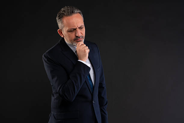 istock Businessman thinking with hand on chin 2212441945