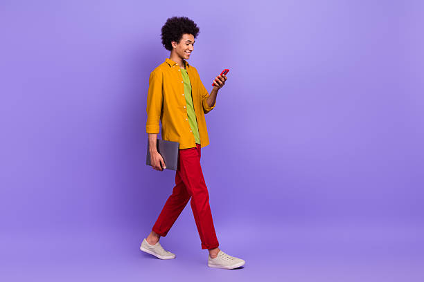 istock Full length photo of youngster stylish nice man hipster walking going work empty space isolated on purple color background 2212444047