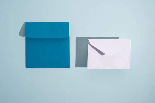 istock Paper envelopes on a light background. New mail, write a message. Send and receive mail. Postal delivery service. Empty envelope, empty space. Communication with people, paperwork. Envelope close-up 2212445100