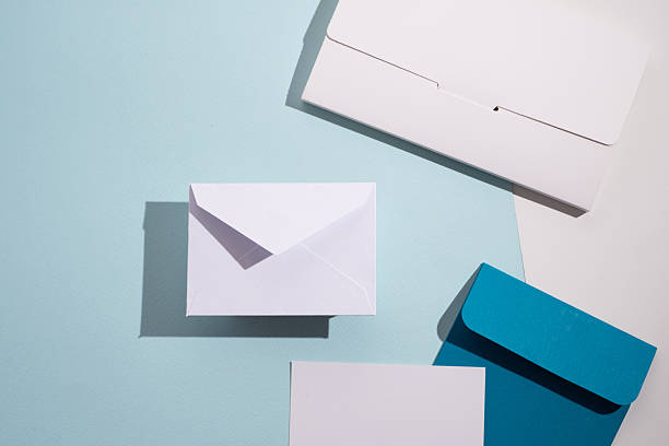 istock Paper envelopes on a light background. New mail, write a message. Send and receive mail. Postal delivery service. Empty envelope, empty space. Communication with people, paperwork. Envelope close-up 2212445118