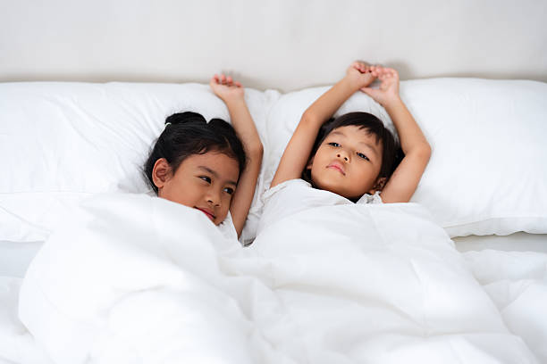 Cute little toddler girl sleeping in bed. Adorable baby child dreaming, healthy sleep of children by day