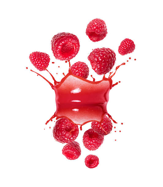 Ripe raspberries in the air with splashes of juice on a white background