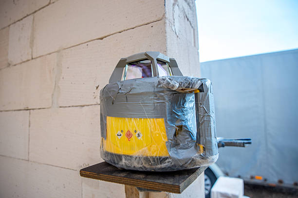 istock Surveying Device Wrapped in Plastic on Wooden Platform Outdoors 2212448882
