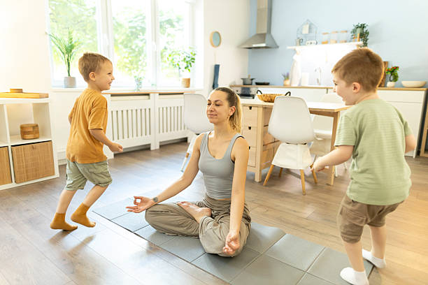 istock Tranquil mother practicing yoga to stay calm with mischievous kids 2212449123