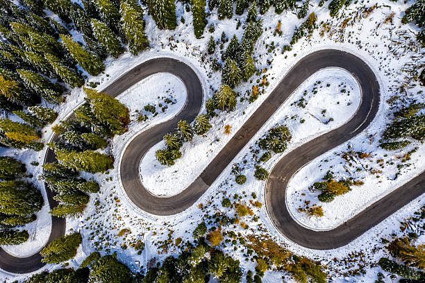 istock Aerial drone view of windy road during winter 2212449359