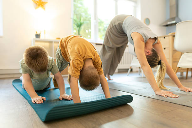 istock Two toddler practicing yoga with their mom 2212450229