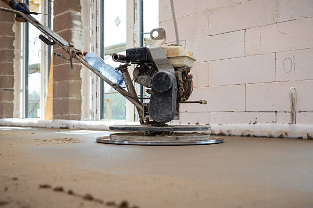 istock Power Trowel Smoothing Concrete Flooring in Construction Site Interior 2212451368