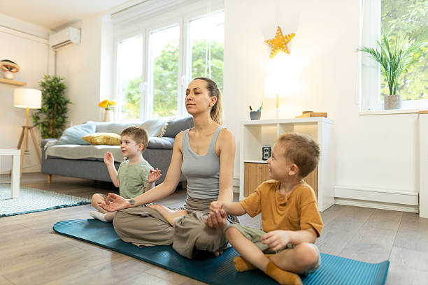 istock Mon and her toddlers in lotus pose for meditation. 2212451564