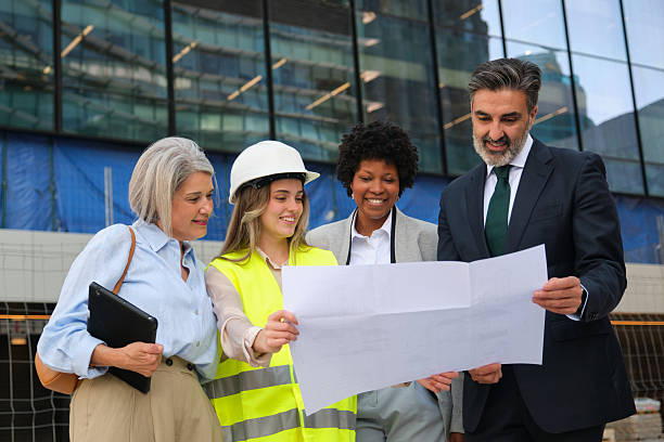Architects and engineers examining blueprints for a new building