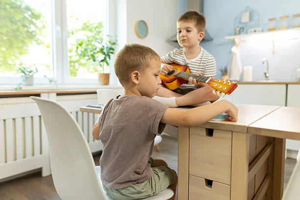 istock Shot of two children exploring musical instruments 2212451944