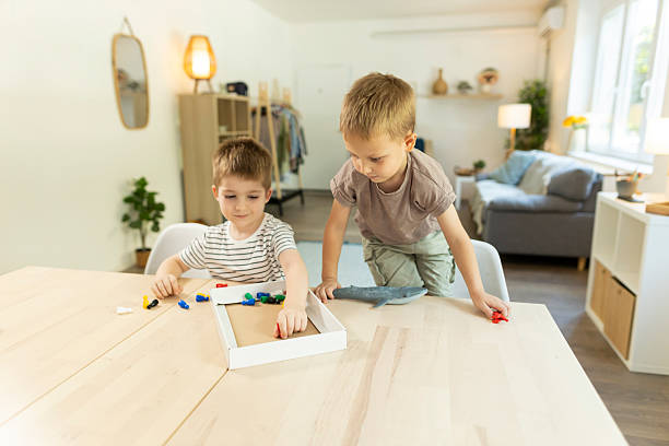 istock Happy boy playing Ludo game with his friend 2212452185
