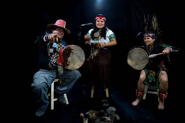 istock Mexican musicians playing pre-hispanic instruments and dancing in a studio 2212452819