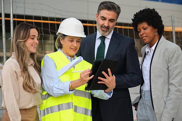 istock Architect showing building project on tablet to investors and colleagues 2212453080