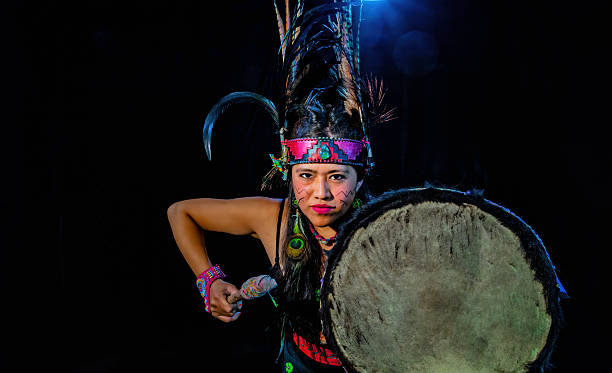 istock Mexican dancer performing traditional dance with drum and feathers 2212453098