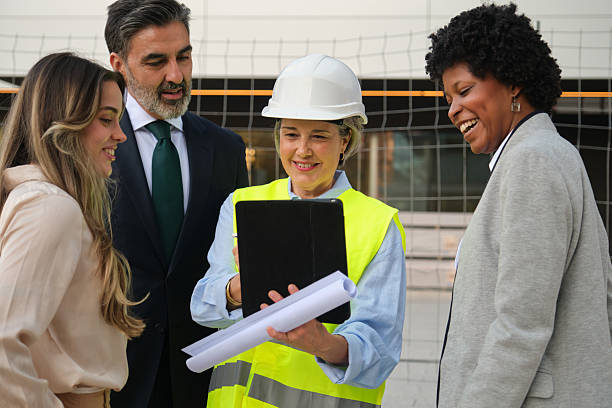 istock Architect showing building plans on tablet to investors and clients 2212453832