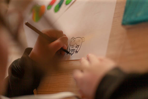 Young child focused on a creative painting activity, using vibrant colors and an artistic setting