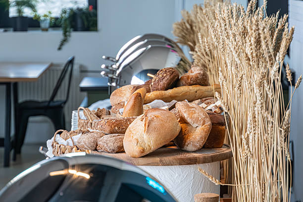istock Bright, well-lit bakery displaying various breads and pastries crusty baguettes, sourdough, artisanal loaves with seeds or grains, rolls, possibly filled pastries Decorative wheat or barley stalks 2212458155