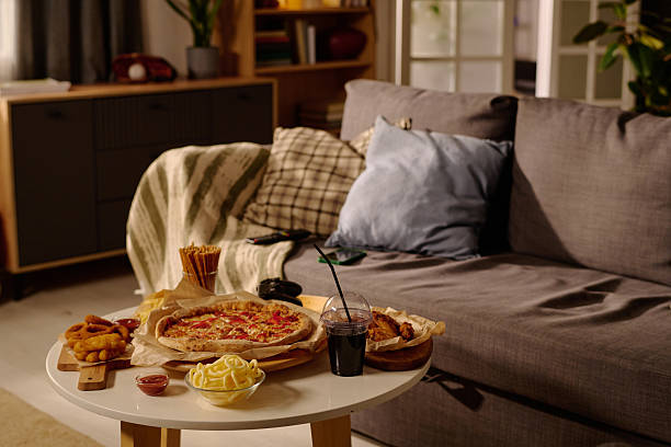 istock Cozy Living Room with Delicious Pizza on Table 2212460274