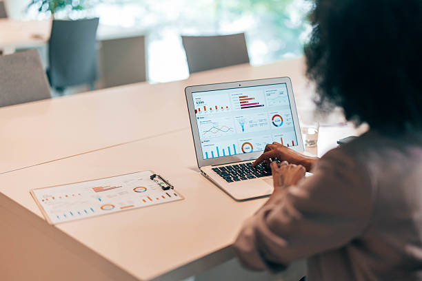 istock Businesswoman analyzing financial data on laptop in modern office 2212460520