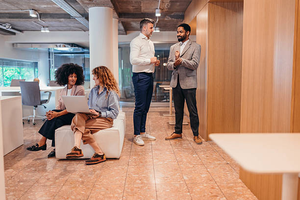 istock Businesspeople discussing during informal meeting in modern office space 2212460584