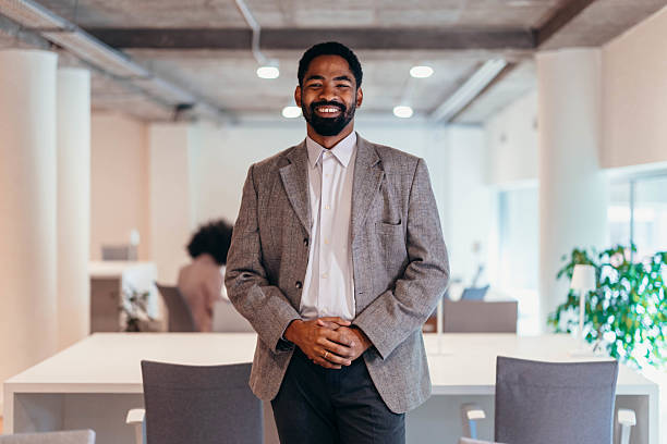 istock Confident young businessman smiling in modern office 2212460730