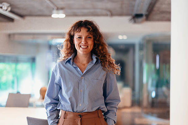 istock Confident businesswoman smiling in modern office space 2212460795