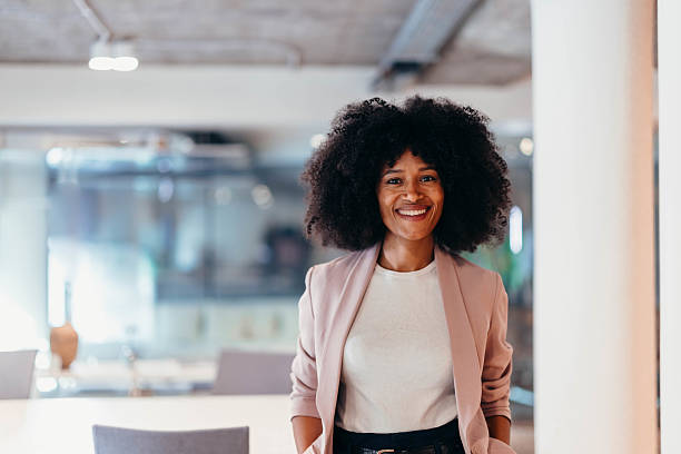 istock Confident businesswoman smiling in modern office space 2212460816