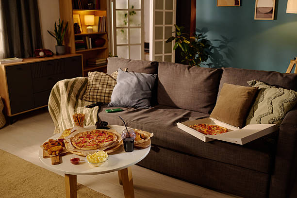 istock Enjoying Pizza and Snacks in a Cozy Living Room Setting 2212460838