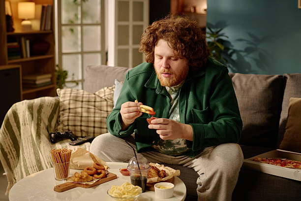 istock Enjoying Dinner While Watching TV in a Cozy Living Room 2212461574