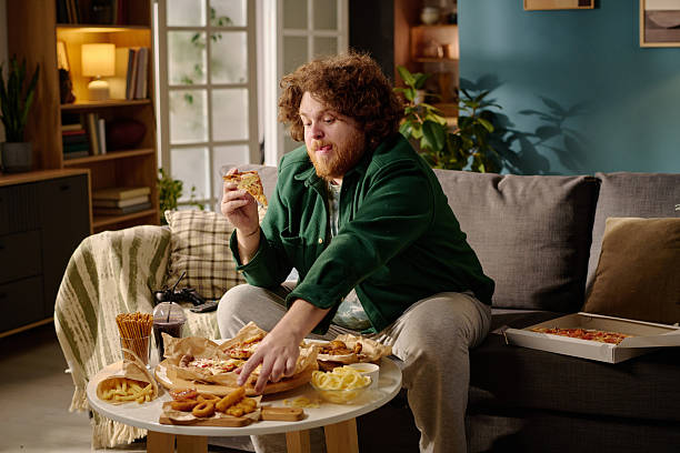 istock Enjoying Pizza and Snacks at Home with Cozy Decor 2212461982