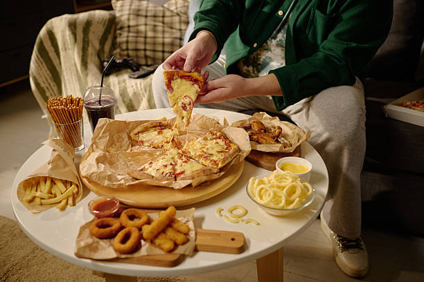 istock Enjoying Delicious Pizza and Snacks at Cozy Home 2212462216