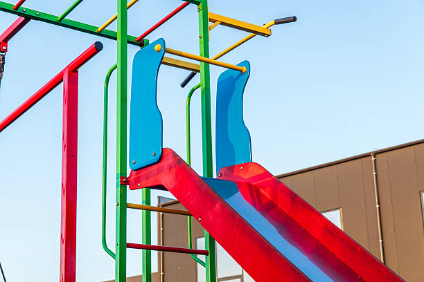 istock Brightly colored playground slides stand ready for children at a community park, reflecting joyful outdoor play on a clear day 2212462265