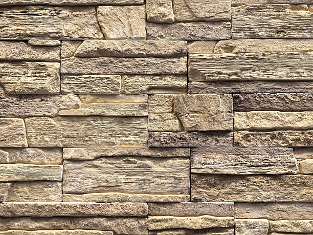 istock Textured wall design with layered stones in neutral shades 2212463450