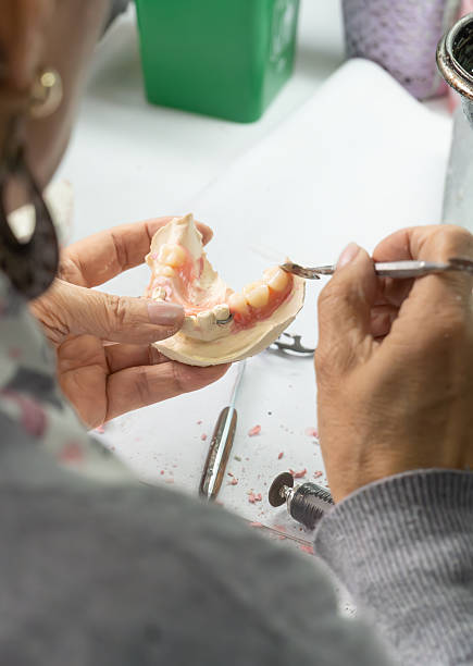 istock Dental Technician Shaping a Dental Mold in Laboratory 2212463789