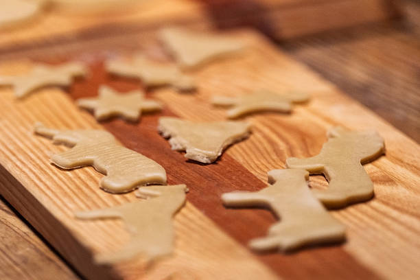 istock Raw Christmas Cookies on Wooden Cutting Board 2212465584