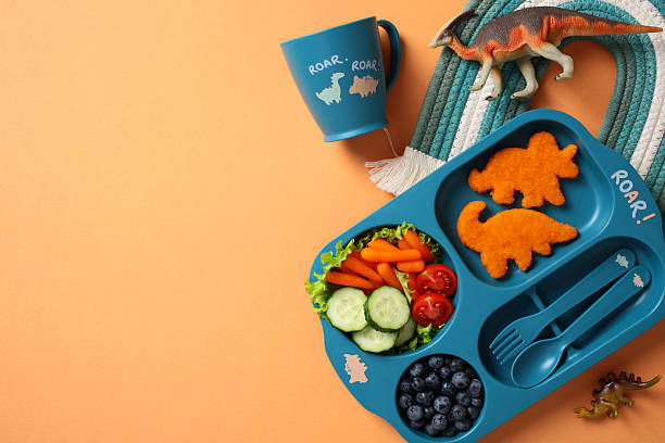 istock Fun dinosaur-themed healthy meal for kids with copy space 2212465766