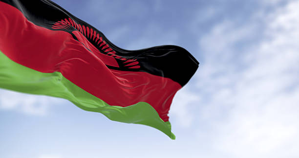 istock Malawian national flag waving outdoors with rising sun symbol. 3D render. 2212468337