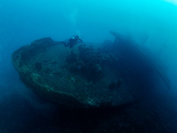 istock scuba diver diving on a sunken ship in the ocean 2212475024